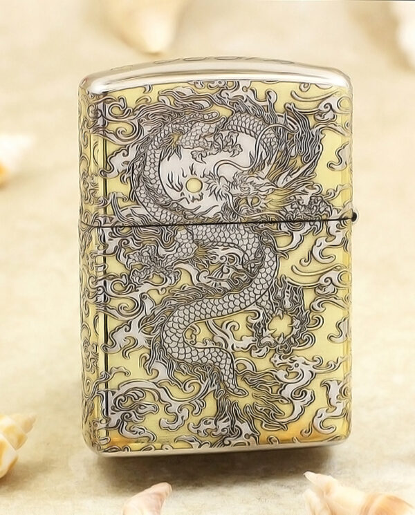 KZ146-01 Metal lighter with an intricate dragon engraving in dark lines on a gold-tone surface.