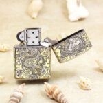 Open KZ146 silver-and-gold Zippo Armor lighter showing the reverse dragon artwork