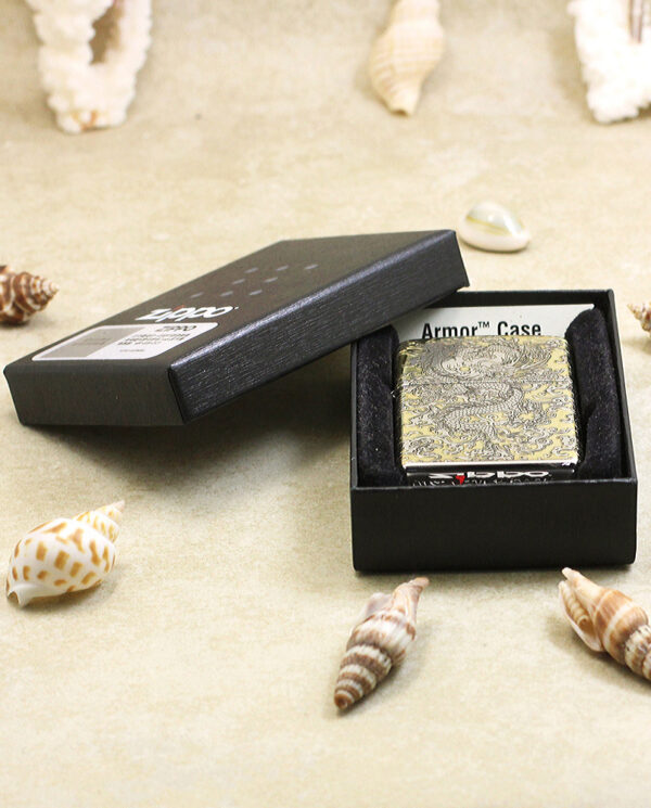 KZ146-06 Open black box reveals a gold ornate case labeled 'Armor Case' inside, surrounded by seashells on a beige surface.