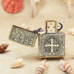 Open brass Zippo Armor lighter showing St. Benedict cross and windproof insert
