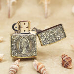 Open brass Zippo Armor lighter showing St. Benedict figure engraving