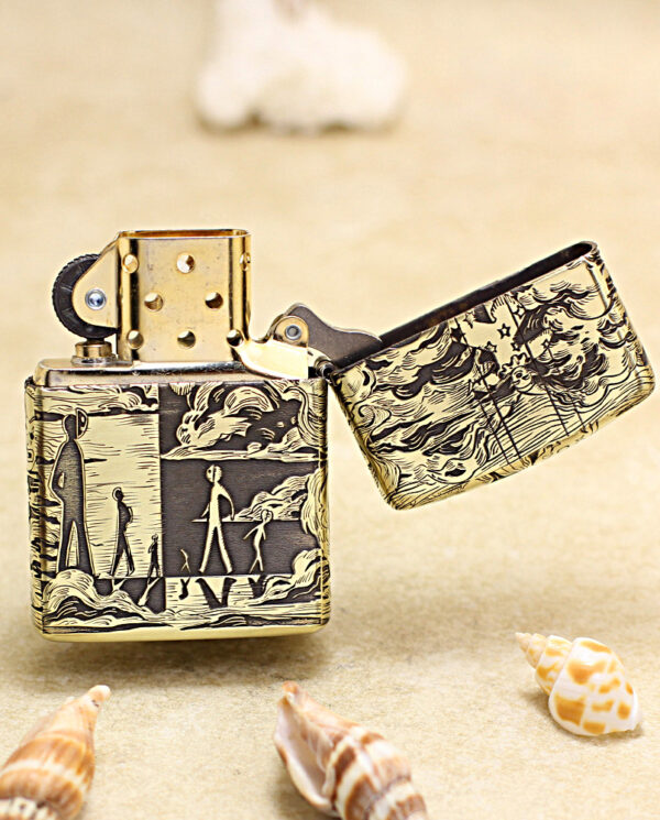 KZ154-03 Decorative metal lighter with a black-on-cream illustration of people on a beach, placed on sand with seashells nearby.