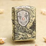Smiling pale clown mask with red cheeks engraved on antique brass Zippo Armor lighter