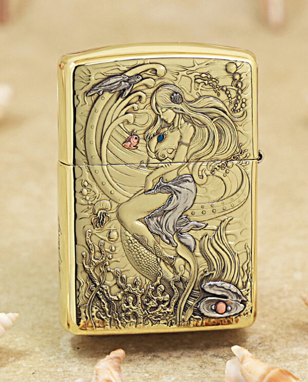 Gold Zippo lighter with a high-relief mermaid underwater scene and seashells engraving on brass surface.