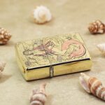 Pink-tailed mermaid engraved brass Zippo Armor lighter lying flat