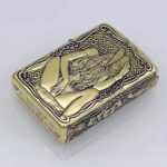 KZ157 pin-up Zippo Armor lighter lying flat with seated woman and ornate border