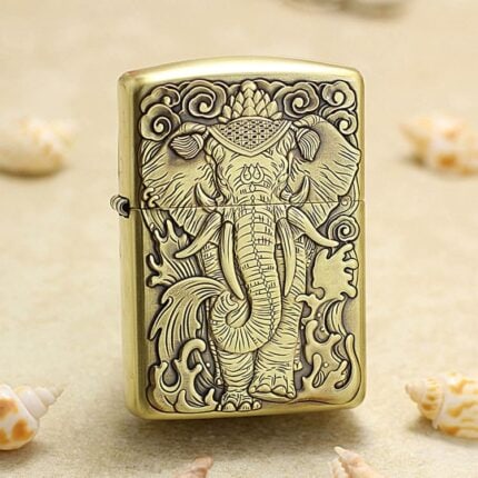 Majestic tusked elephant engraved on the front of antique brass Zippo Armor lighter