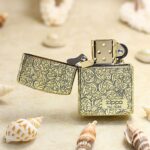 Open numbered arabesque Zippo Armor lighter showing front plaque and lid engraving