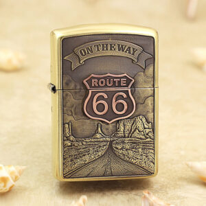 Brass lighter with a Route 66 desert scene and 'On the Way' banner engraved on the front panel