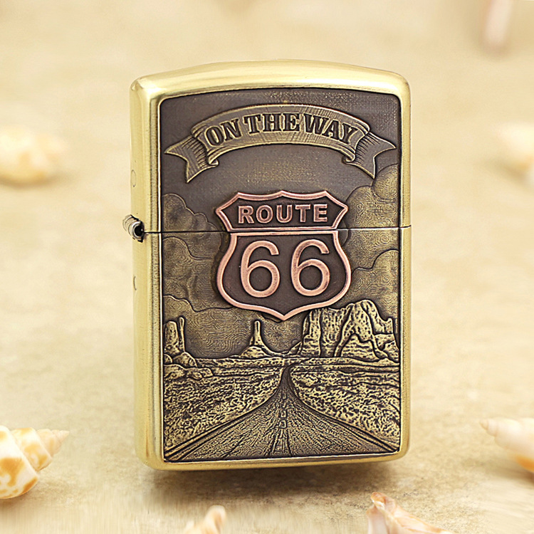 Brass lighter with a Route 66 desert scene and 'On the Way' banner engraved on the front panel
