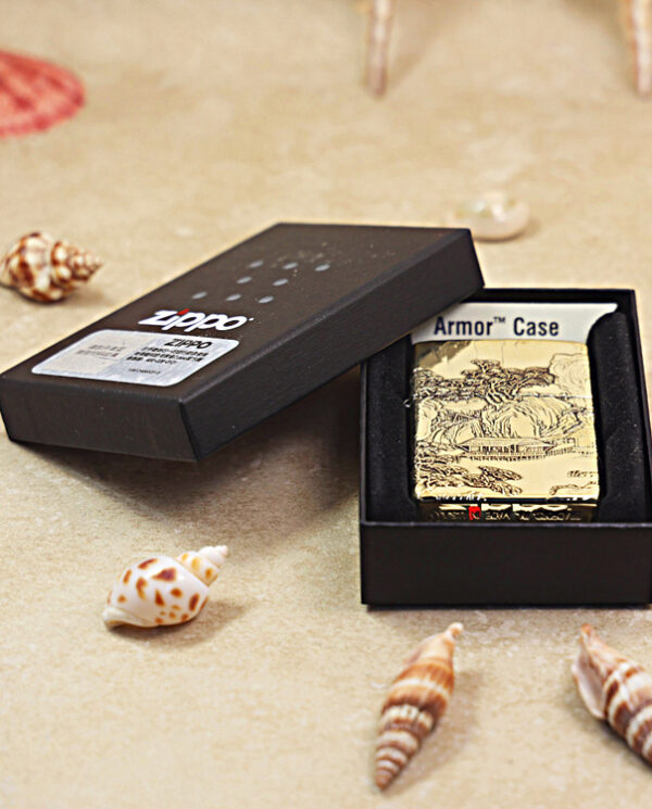 KZ162-06 Black Zippo lighter in its open black box on a sandy beach with seashells nearby.