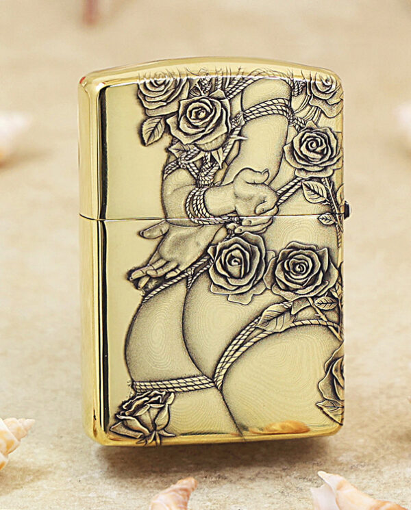 Gold Zippo lighter with ornate rose engravings and flowing vines in a decorative pattern.