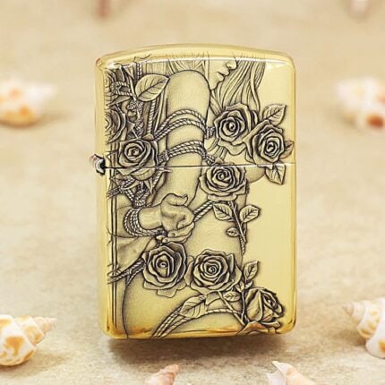 Polished brass Zippo Armor lighter with a stylized lady figure framed by engraved roses