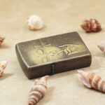 Two-sided Buddha engraved antique brass Zippo lighter lying flat