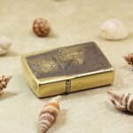 Tiger and cub engraved brass Zippo Armor lighter lying flat