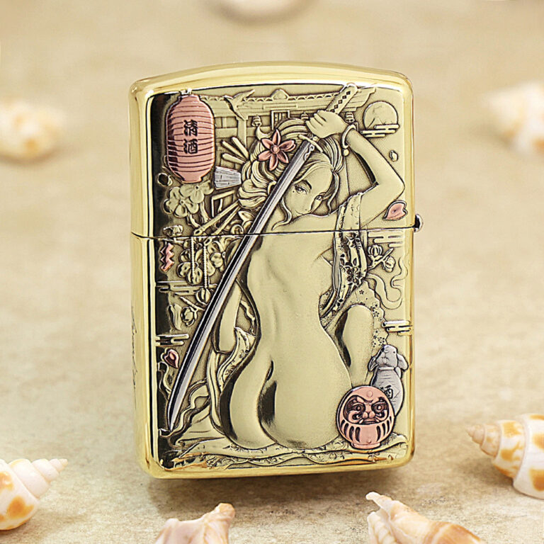 Gold Zippo lighter with an engraved Japanese geisha, sword motif, and floral background accents in a polished finish.