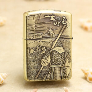 Gold Zippo-style lighter with a backward-facing samurai in armor, holding a spear, set against a mountainous village scene in relief on the surface.