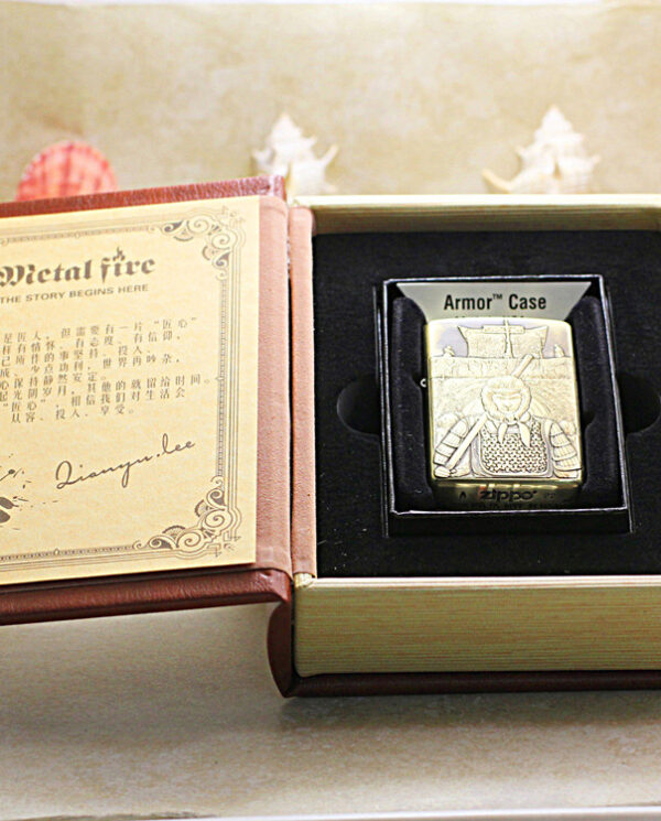 KZ190-06 Zippo lighter with an engraved armor design in a foam insert, inside a beige presentation box.