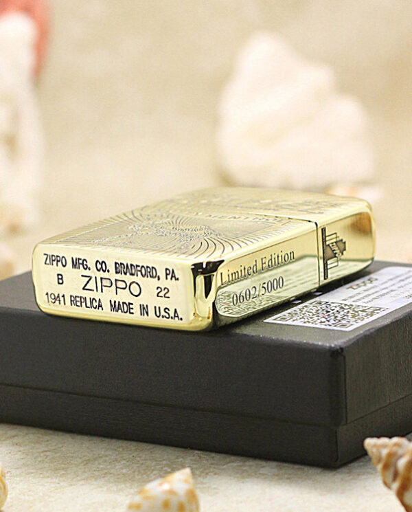 Gold Zippo lighter labeled Limited Edition, made in the USA, resting on a black box.