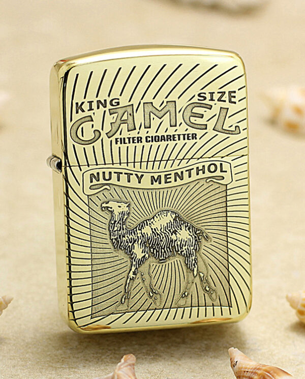 Gold Zippo-style lighter with Camel brand artwork, reading Nutty Menthol and featuring a camel illustration on a sunburst background.