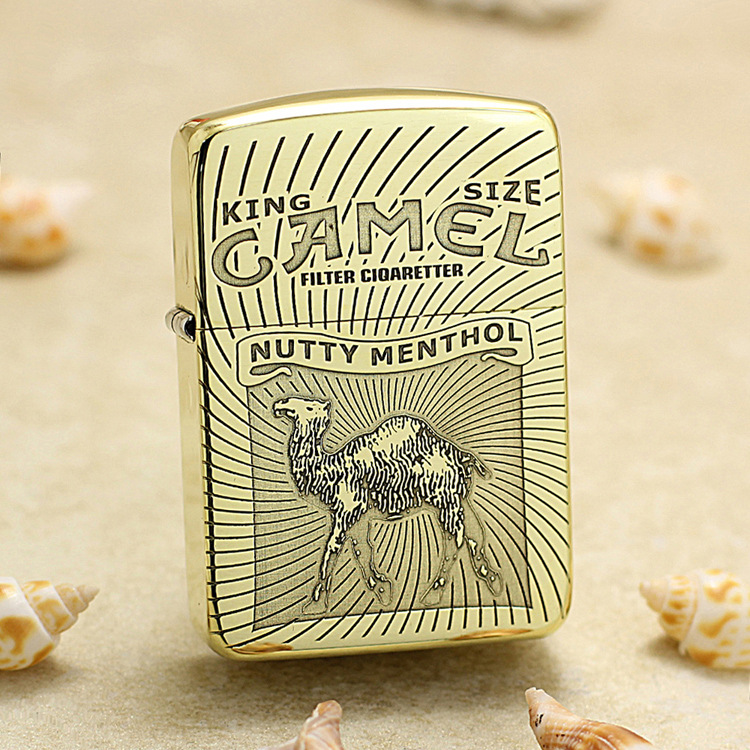 Gold Zippo-style lighter with Camel brand artwork, reading Nutty Menthol and featuring a camel illustration on a sunburst background.