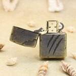 Open Beast Scratch bronze-tone Zippo Armor lighter with dark leather wrap