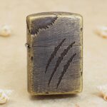 Beast Scratch bronze-tone Zippo Armor lighter with cracked-leather panel