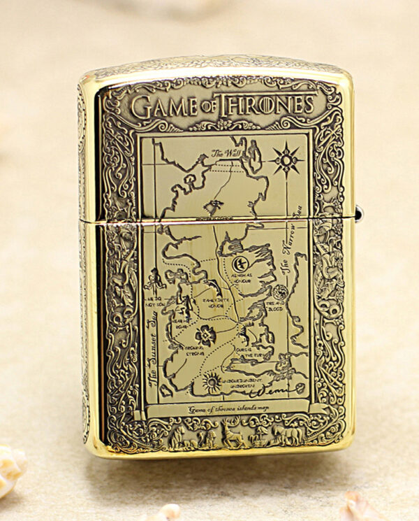 KZ196-01 Gold-toned lighter engraved with a Game of Thrones map design on the front, ornate border surrounding the map.