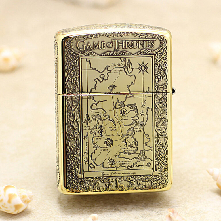 Gold-toned lighter engraved with a Game of Thrones map design on the front, ornate border surrounding the map.