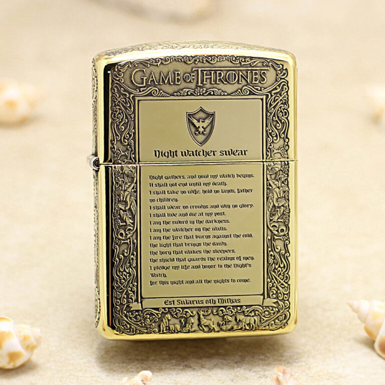 Gold-toned lighter engraved with Game of Thrones motifs and 'Night watcher swear' text on a parchment panel