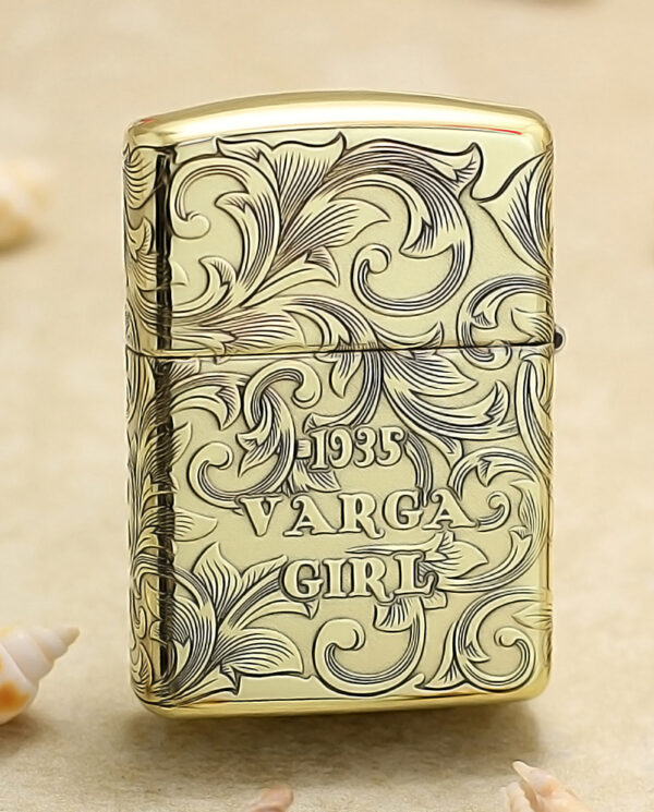 KZ202-01 Gold-tone lighter with intricate scrollwork engraving reading '1935 VARGA GIRL'.