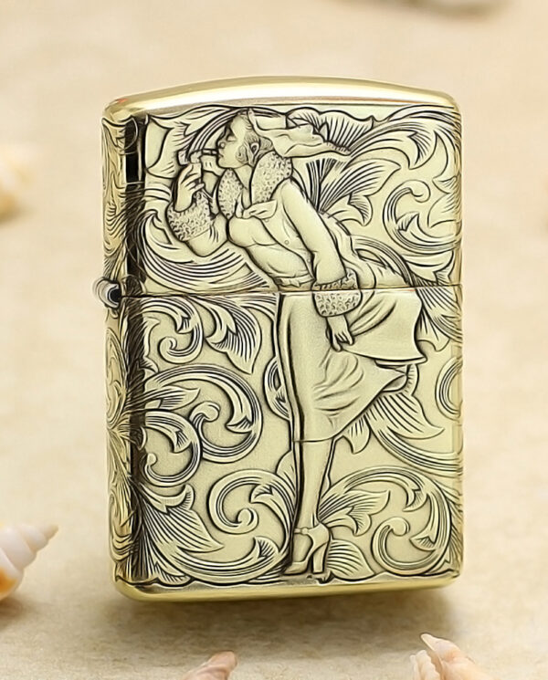 KZ202 Gold Zippo-style lighter with a detailed engraving of a woman in a dress amid swirling patterns.