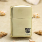 Gold metal lighter with brushed finish, showing the Transformers Autobot logo and No.0096.