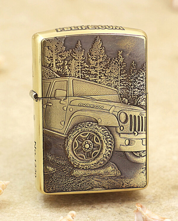 KZ209 Gold-toned lighter with a detailed engraving of a Jeep Rubicon off-road vehicle and a forest backdrop on its front face.