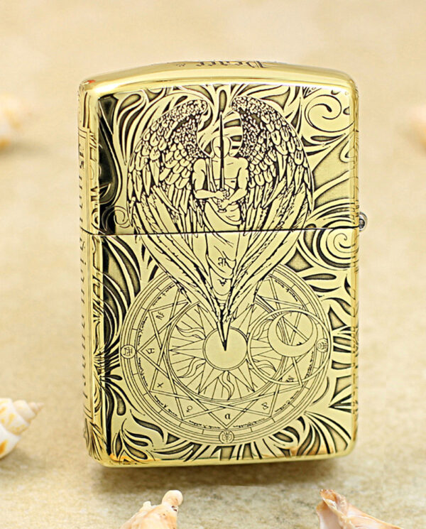 KZ211-01 Gold engraved Zippo lighter with an angel wings design above a circular geometric seal from the engraving on the front surface.