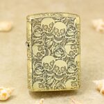 Skull and Roses high-polish brass Zippo Armor lighter front view