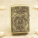 Lighter with ornate World of Warcraft embossing and crest on a beige background.