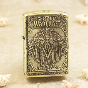 Gold-toned Zippo-style lighter with embossed World of Warcraft artwork and ornate fantasy armor motif, including the game logo at the top