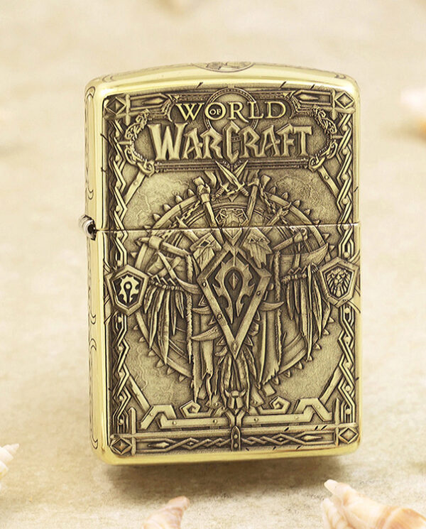 KZ217 Gold-toned Zippo-style lighter with embossed World of Warcraft artwork and ornate fantasy armor motif, including the game logo at the top