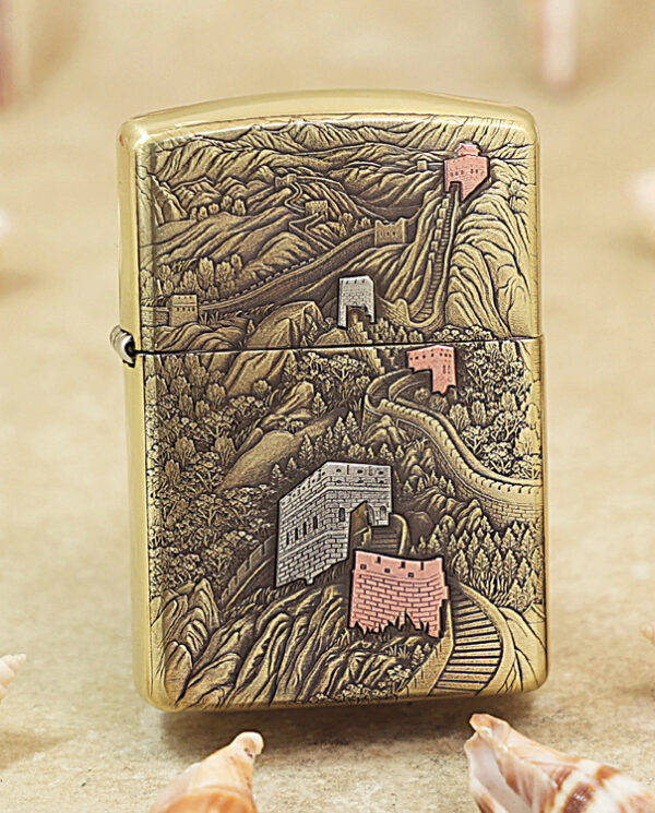 Brass Zippo lighter with an intricate engraving of the Great Wall winding over mountains.