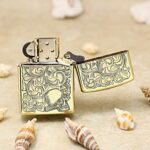 Open woman and skull Zippo Armor lighter with dense arabesque engraving