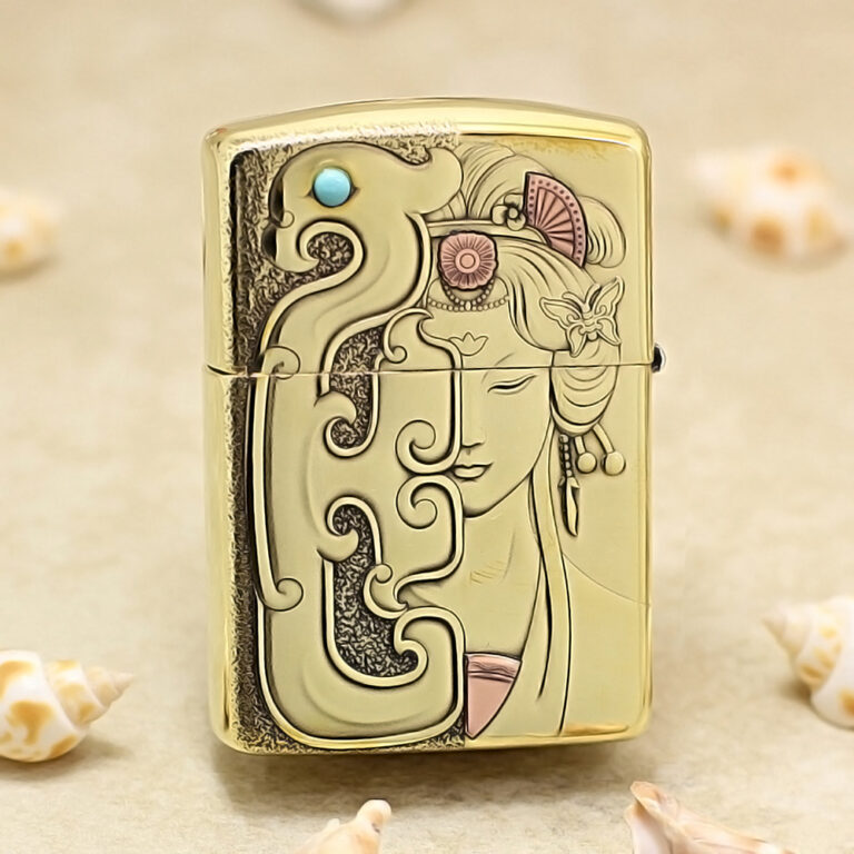 Gold-toned Zippo-style lighter with an Art Nouveau design featuring a woman's face and swirling patterns.