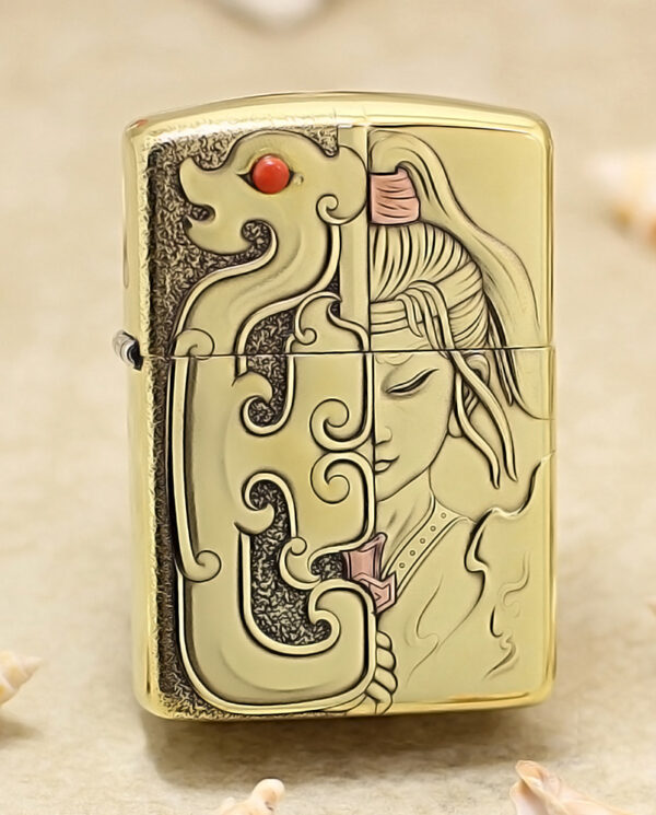 Gold-tone lighter featuring a split design: an ornate dragon on the left and a calm, stylized woman's profile on the right.