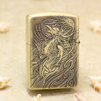 Brass Zippo-style lighter with an ornate, engraved dragon and swirling wave patterns on the front surface.