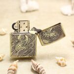 Open Phoenix Zippo Armor lighter with wraparound engraved design