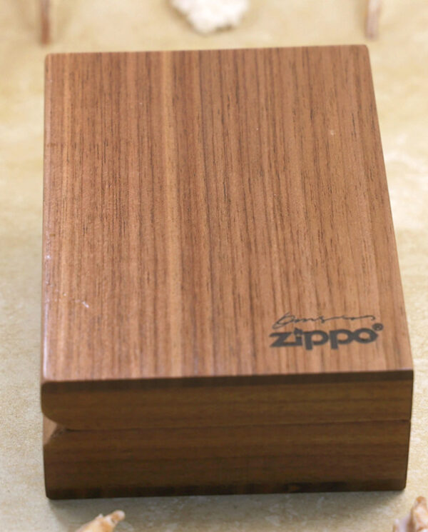 KZ229-07 Wooden Zippo lighter case on a light surface, close-up of the wood grain and logo