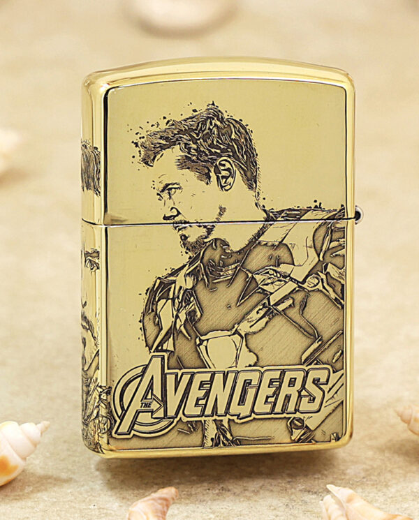 KZ241-01 Gold-colored lighter featuring a stylized Avengers illustration and the Avengers logo at the bottom.