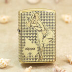 Gold-tone Zippo lighter with a stylized woman smoking motif set against a star-patterned background