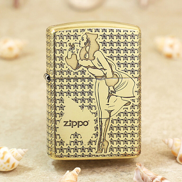 Gold-tone Zippo lighter with a stylized woman smoking motif set against a star-patterned background