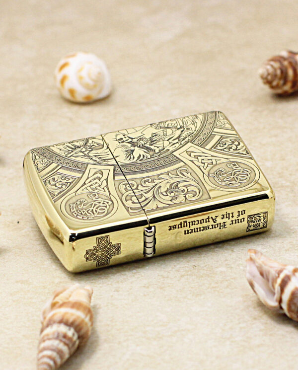 KZ245-04 Gold ornate lighter with intricate engravings on a sandy beach, surrounded by seashells